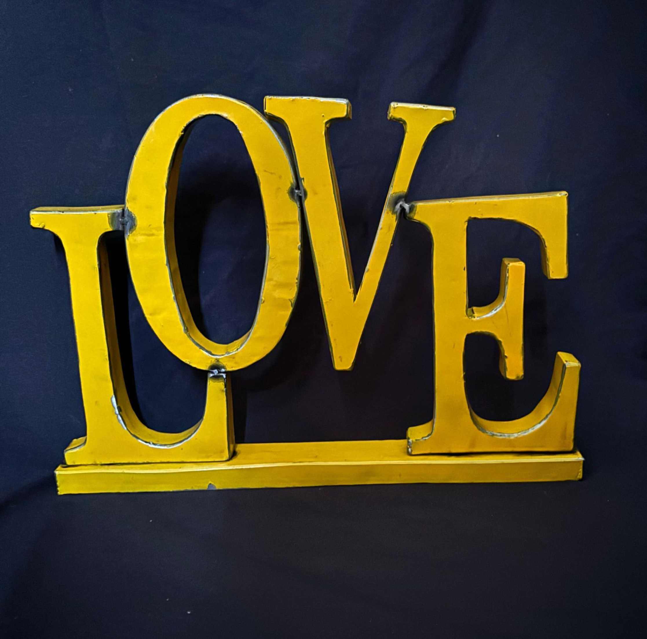Yellow LOVE sign from recycled drums